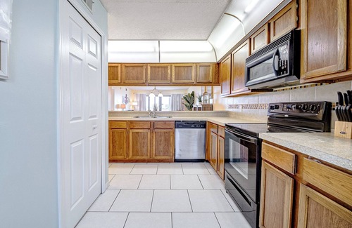 Cocoa Beach Condo | Comfortable, Coastal, Beachy Condo with Balcony, Pool, Tennis Court & Family Fun!
