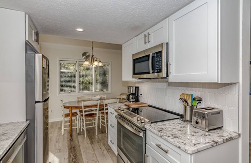 Bald Head Island Condo | Condo with community pool and balcony with forest view, recently renovated
