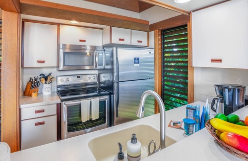 Poipu House | Corner condo with garden view, lanai, pool & hot tub - walk to Kiahuna Beach