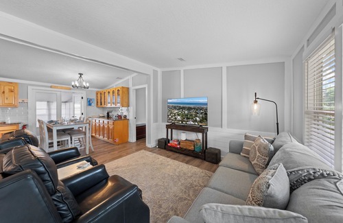 Butler Beach House | Cozy Canal Escape! Screen Covered Pool, Sunroom, Sun Deck, & Floating Boat Dock