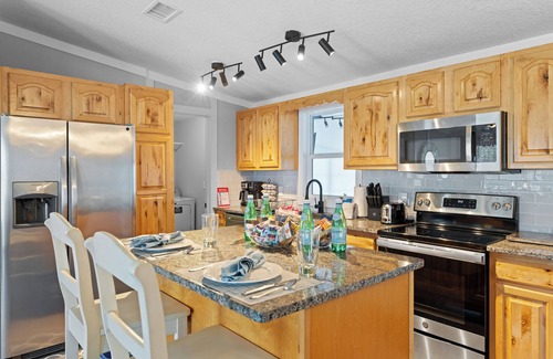 Butler Beach House | Cozy Canal Escape! Screen Covered Pool, Sunroom, Sun Deck, & Floating Boat Dock