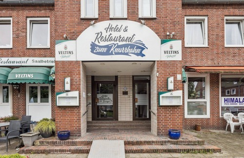 Wilhelmshaven Hotel | Cozy double room, seating area, flat-screen TV, and modern bathroom with shower. Ideal for couples and short stays – enjoy a relaxed atmosphere with warm wood accents and coastal charm.