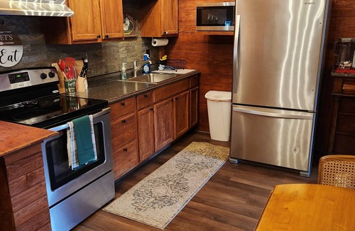 Ellabell Cabin | Cozy fishing cabin with stocked pond, near Savannah. Fenced- pet friendly!