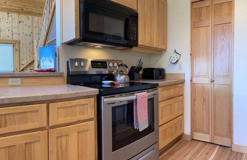 Redmond Ski Chalet | Cozy knotty pine chalet with creekside deck, BBQ, and access to pools, hot tubs, gym, golf, hiking.
