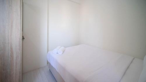Surabaya Apartment | Cozy Living and Tidy 2BR at Puncak Dharmahusada Apartment By Travelio