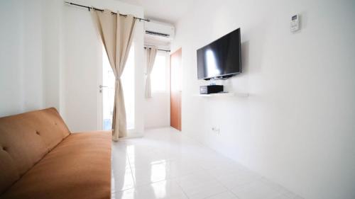 Surabaya Apartment | Cozy Living and Tidy 2BR at Puncak Dharmahusada Apartment By Travelio