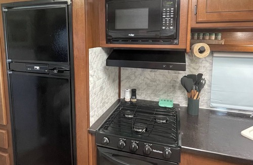 Aztec House | Cozy RV on working farm. 1 bedroom with queen size bed, 2 twin size beds.