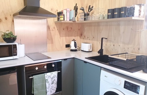 Croydon Park Apartment | Cozy studio with trendy design, fully equipped kitchen, & modern bathroom.
