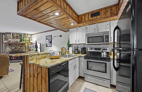 Chalet Village Condo | Creekside Condo Retreat With Fireplace & Patio