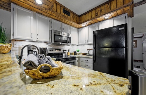Chalet Village Condo | Creekside Condo Retreat With Fireplace & Patio