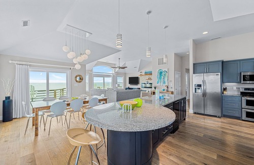 Salvo House | Dazzling waterfront home with balconies, private pool, hot tub, & game room