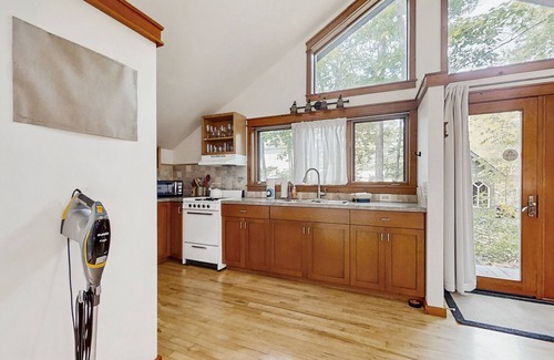 Glen Arbor Cottage | Downtown cottage with nearby beach access, a grill, deck, & washer/dryer