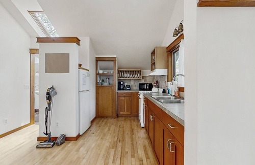 Glen Arbor Cottage | Downtown cottage with nearby beach access, a grill, deck, & washer/dryer