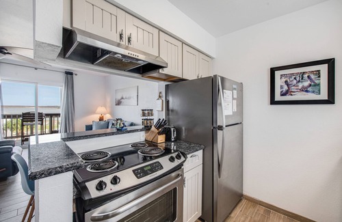 Port Aransas Condo | Drink your morning coffee on the deck watching the ships pass by.