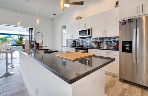 Pelican House | Elegant Modern Home on Salt Water Canal w/Heated Pool