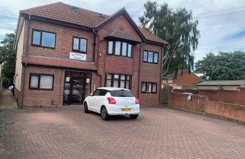 Wednesbury Apartment | Enjoy a spacious lounge with a cozy sofa bed and a private ensuite bedroom