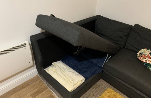 Wednesbury Apartment | Enjoy a spacious lounge with a cozy sofa bed and a private ensuite bedroom