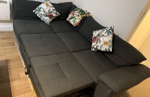 Wednesbury Apartment | Enjoy a spacious lounge with a cozy sofa bed and a private ensuite bedroom