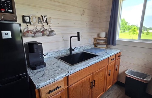 Tuscumbia Cabin | Enjoy cabin #64 at Heritage Acres Park with swimming, splash pad & more!