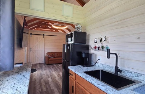 Tuscumbia Cabin | Enjoy cabin #65 at Heritage Acres Park with swimming, splash pad & more!