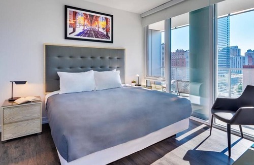 Near North Side House | Enjoy city views in our studio with one queen bed, furnished kitchen and a deluxe bathroom.