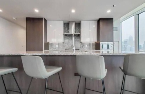 Near North Side House | Enjoy city views in our studio with one queen bed, furnished kitchen and a deluxe bathroom.