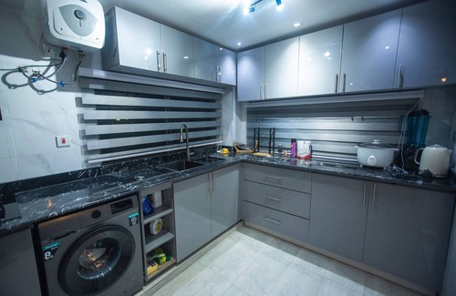 Kumasi Apartment | Exec 2BR Aptmt with modern kitchen, WiFi, cozy bedrooms, study area, and hall