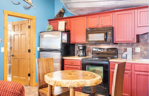 Branson Theater District Cabin | Fishing Themed Retreat for Two - King Bed Cabin with Fireplace & Jacuzzi Tub