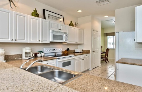 Naples Condo | Genoa Vacation Rental: Stylish 2-BR Condo with Golf & Lake Views. Resort-Style Pool, Hot Tub, and Easy Access to Championship Golf. Minutes from Naples Beaches, 5th Avenue S, and Marco Island