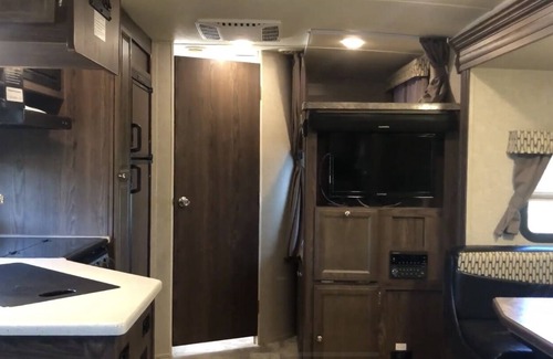 Lafayette House | Glamp in a cozy RV waking up to Nature Trails out your front door.