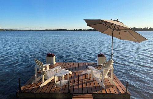 Rideau Lakes Cottage | Glamping anyone? Enjoy picturesque sunsets from your own water’s edge deck!