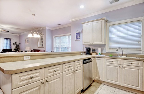 Central Myrtle Beach Condo | Ground-floor golf condo with pool, on-site golf, screened patio, fireplace, & AC