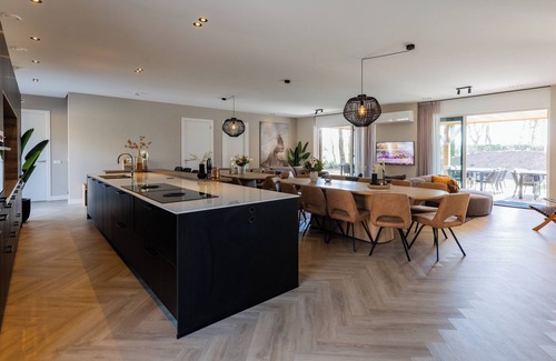Wekerom House | Heide Villa offers luxury for 26 guests, with 10 bedrooms, ensuite bathrooms, hot tub, sauna, and large garden.