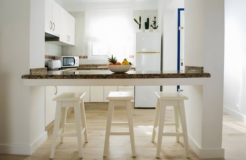 Arrieta House | Holiday Home 'Caleta Campos Bungalows' with Sea View, Shared Pool and Wi-Fi