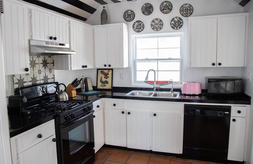 Dunmore Town House | Iconic Waterfront Cottage with Sunset Porch