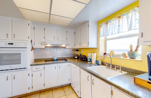 South Patrick Shores Condo | Inviting condo with ocean view, balcony, full kitchen, central AC, & W/D