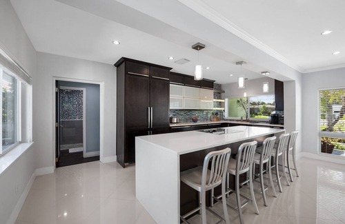 Central Fort Lauderdale House | Just 10min to downtown Ft. Lauderdale & beach, this modern home offers everything a group could want for an upscale relaxing getaway. Unwind in the very private and peaceful backyard oasis, featuring a heated ($) pool, 6-person hot tub & fire pit.