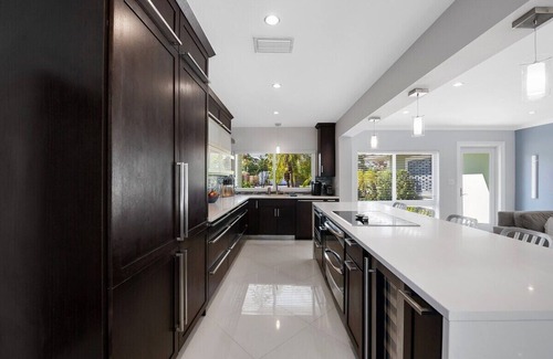 Central Fort Lauderdale House | Just 10min to downtown Ft. Lauderdale & beach, this modern home offers everything a group could want for an upscale relaxing getaway. Unwind in the very private and peaceful backyard oasis, featuring a heated ($) pool, 6-person hot tub & fire pit.