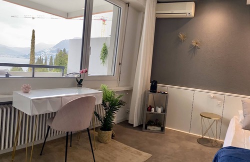 Bissone Apartment | Lake view apartment with terrace, outdoor pool and parking space