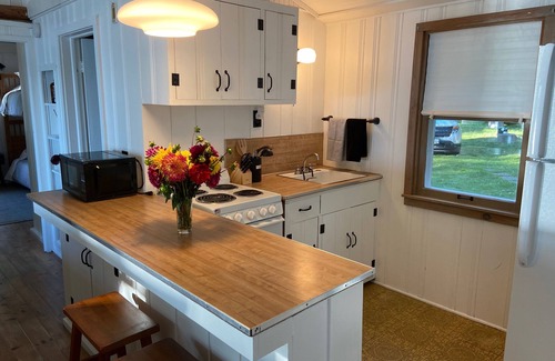 Baileys Harbor Cottage | Lakefront Cottage Retreat w/Private Dock, Paddle Boards, Fire Pit, Sunset Views