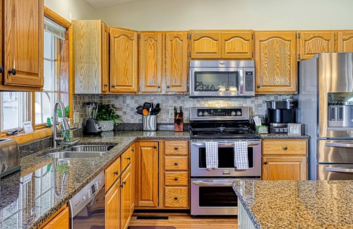 Sandy Point House | Lakefront retreat with a large yard, stone fire pit, gazebo, deck, & dock