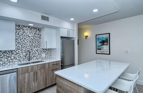 Longboat Key Condo | LaPlaya 101A - Step out to the beach from your screened lanai. Light and bright end unit.