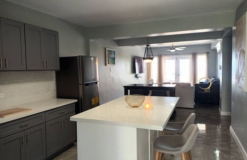 IronShore Estates Apartment | Large Family 2 bedroom 2 bathroom apartment in Ironshore. Kitchen. Pool, lounge