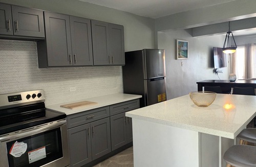 IronShore Estates Apartment | Large Family 2 bedroom 2 bathroom apartment in Ironshore. Kitchen. Pool, lounge