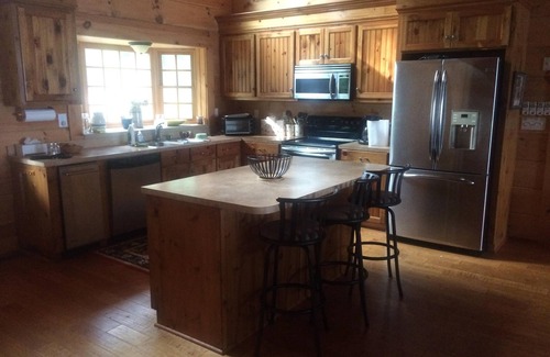 Gilbert House | Large Log Cottage: Green Grass, Blue Skies, Lake Living