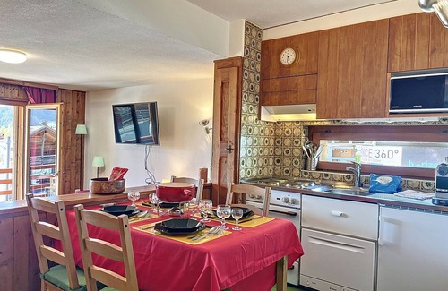 Verbier Apartment | Living room with sofa bed, open-plan kitchen with 3 hotplates and Nespresso coffeemachine, small dis
