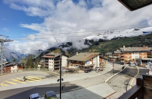Verbier Apartment | Living room with sofa bed, open-plan kitchen with 3 hotplates and Nespresso coffeemachine, small dis