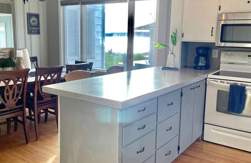 Traverse City House | Located directly on East Grand Traverse Bay with sandy beach