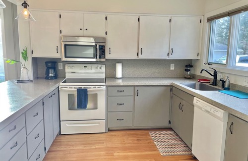 Traverse City House | Located directly on East Grand Traverse Bay with sandy beach