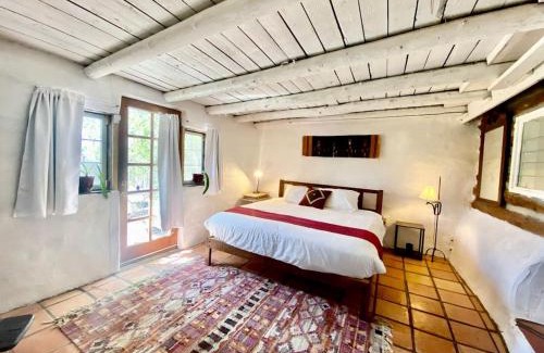 San Cristobal House | Log Casita Overlooking Pond and Waterfall near Taos, New Mexico